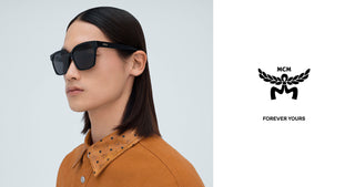 A male model wearing black MCM rectangular sunglasses and a brown collared shirt. The right side of the image features the black MCM logo with the words 'FOREVER YOURS' on a white background.